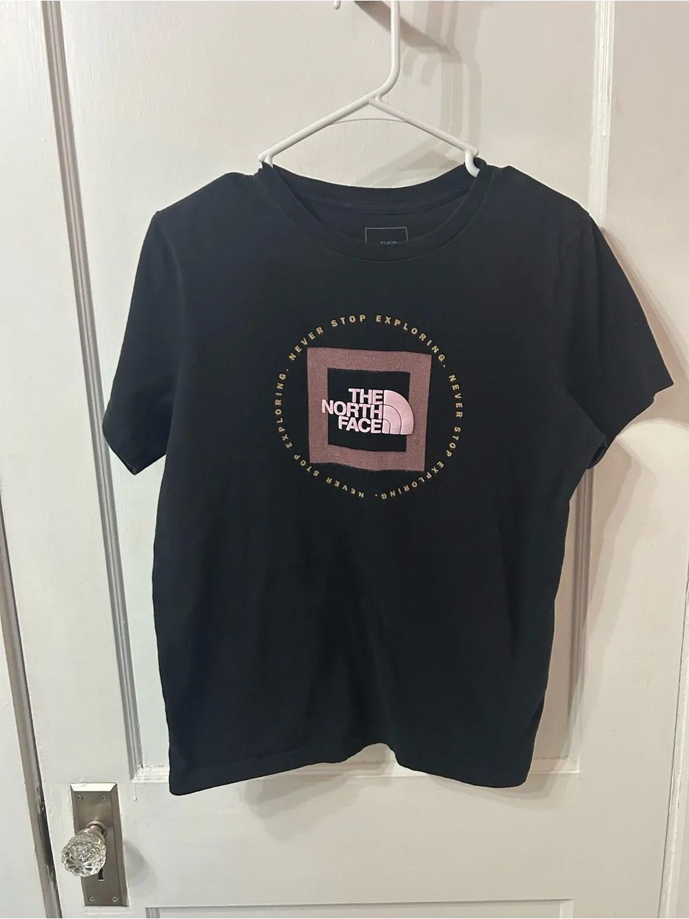 The North Face Black Tee with Dusty Rose Square and Gold Text